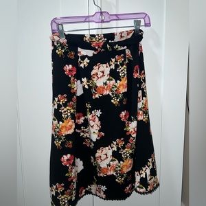 Black and floral Medium Petite Woman’s skirt with minimal lace ending.